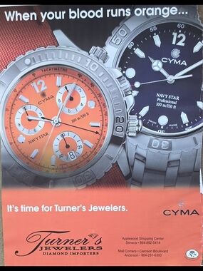 Print ad features two models: orange-dial chronograph on left and a black-dial